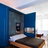 Bett und blauer Kleiderschrank